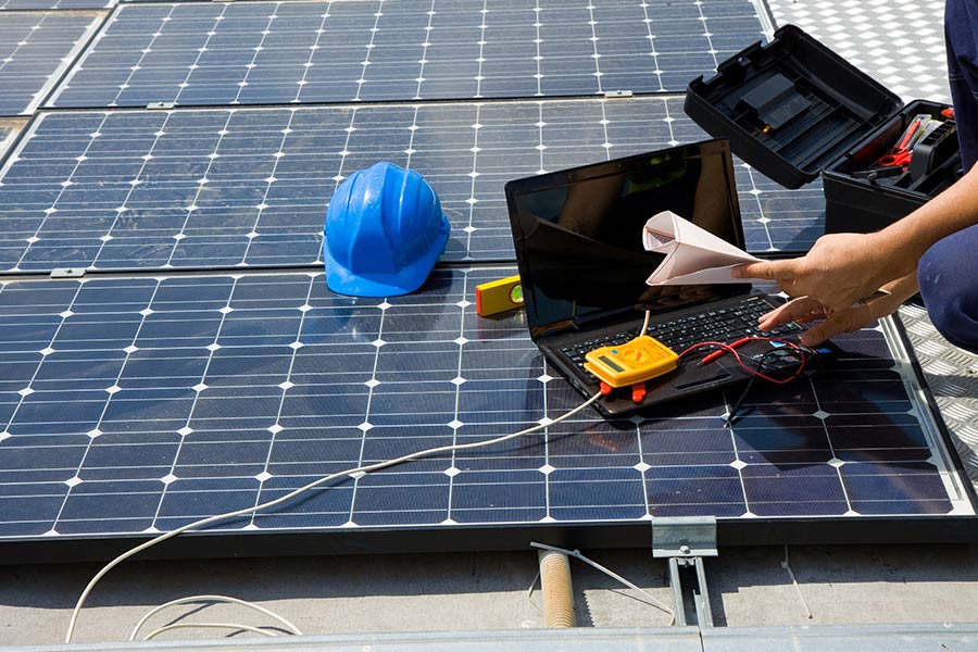 technician working with solar panel